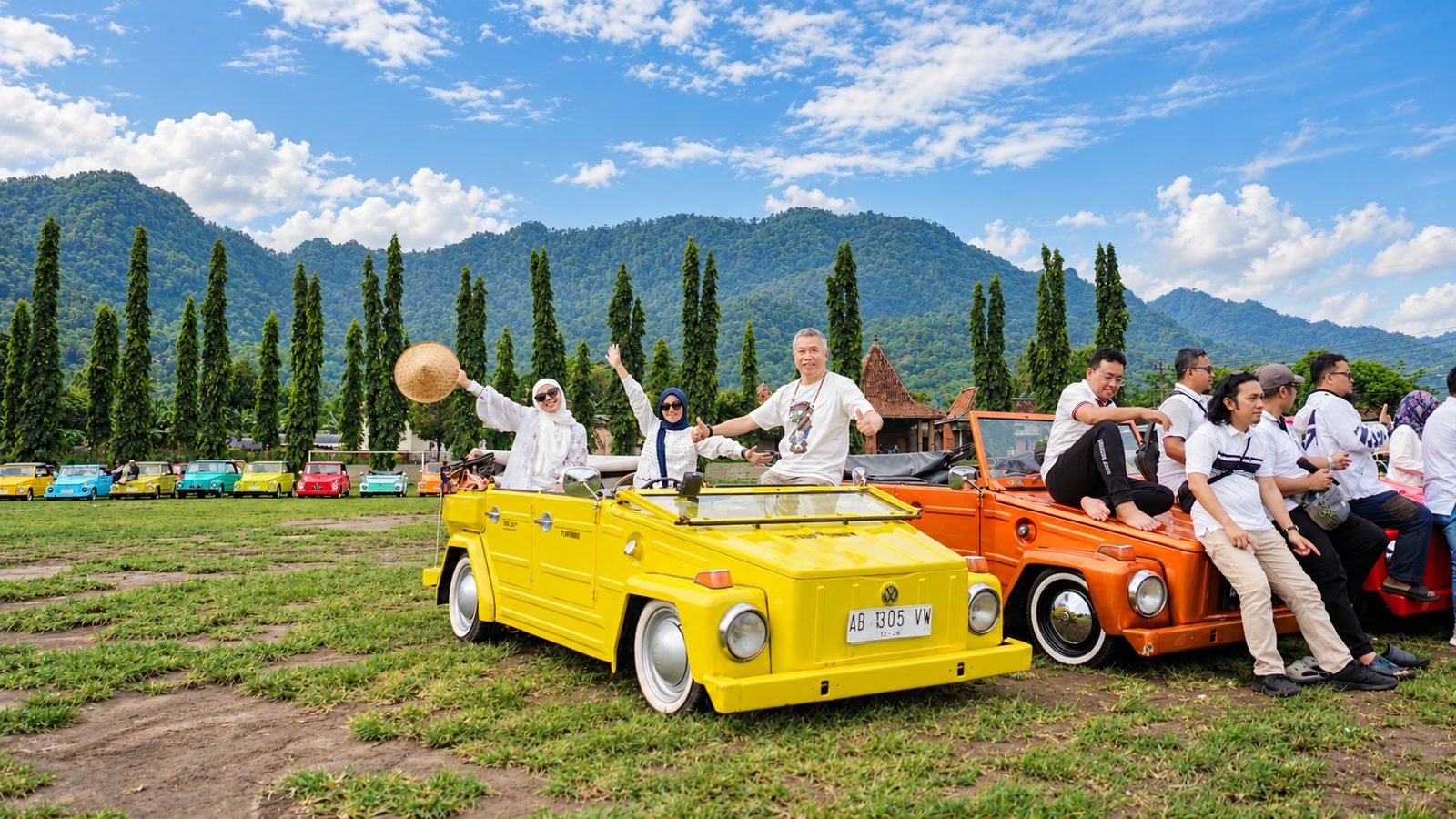 Group of travelers waving from classic VW cars on a VW safari near Borobudur